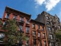 Row of Colorful Old Brick Apartment Buildings with Fire Escapes in Williamsburg Brooklyn of New York City by Shutterstock
