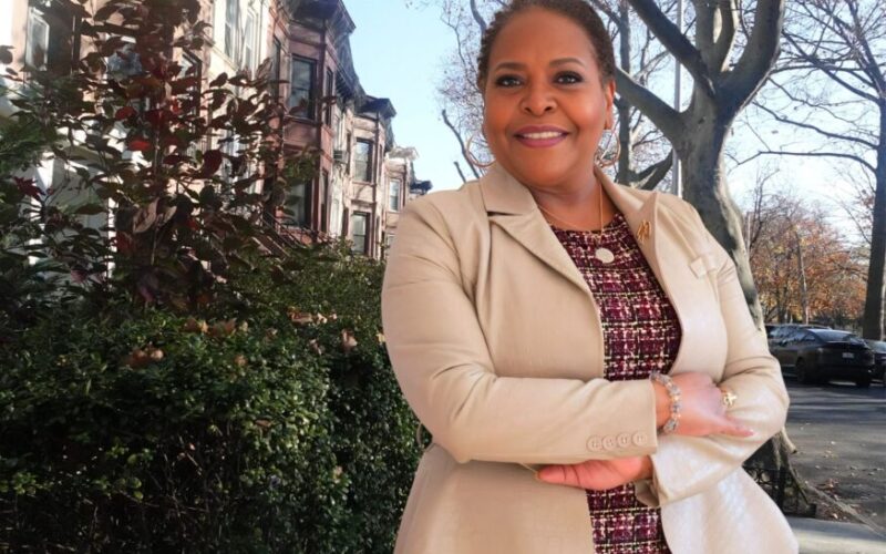 Stefani Zinerman in Bed Stuy with brownstones in the background photo by lifesabashinc