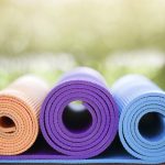 many yoga mats on the wood table in the garden